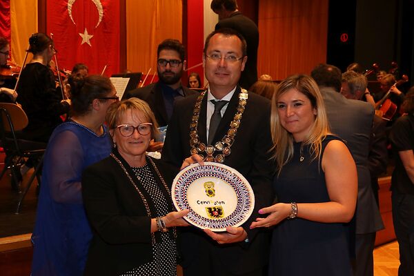 Auf dem Bild ist der damalige Oberbürgermeister Thilo Rentschler mit zwei Frauen zu sehen, die einen Teller, der die Partnerschaft zwischen Cervia und Aalen symbolisiert, in die Kamera halten.