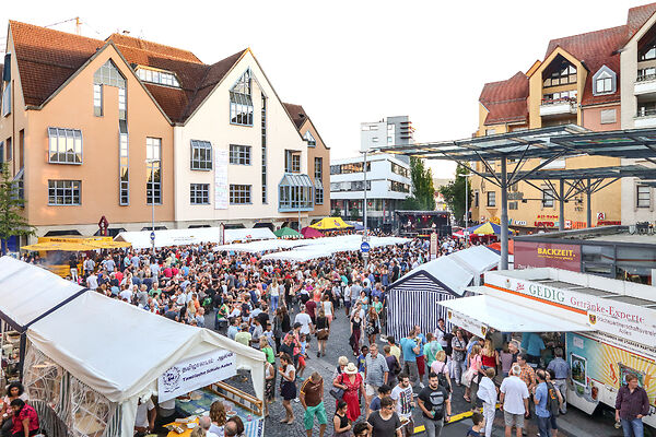 Auf dem Bild ist der Marktplatz mit Marktständen und vielen Besuchern des Internationalen Festivals 2019 zu sehen.